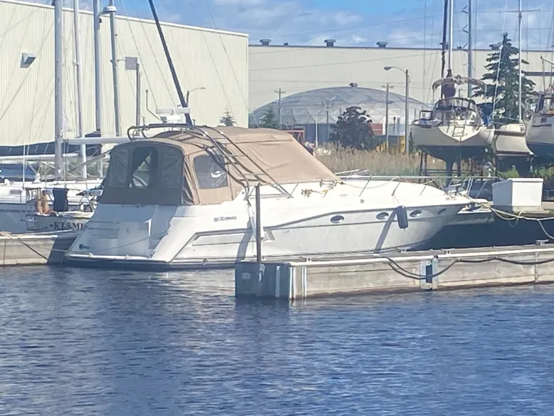 Slide: The Image of 1993 Cruisers 3675 yacht docked at a marina on a sunny day. - 4