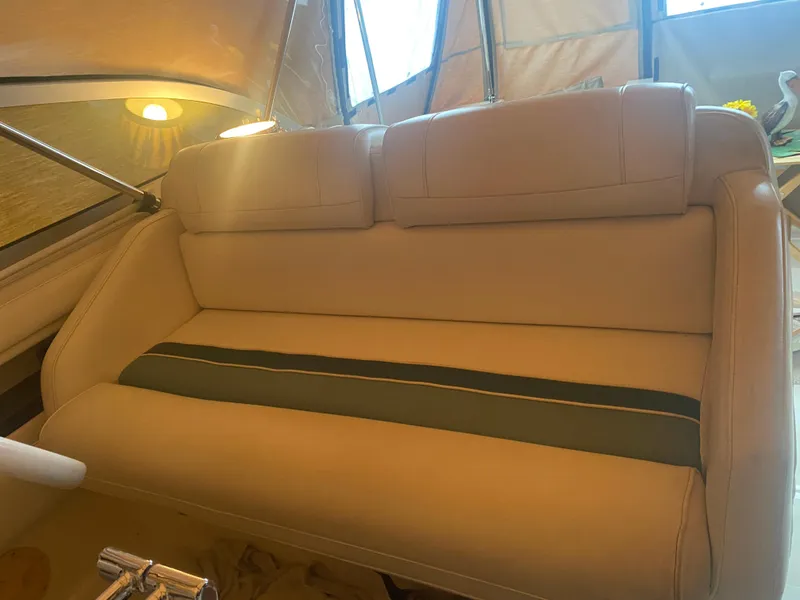 Slide: The Image of 1993 Cruisers 3675 boat interior with beige seating and green stripe. - 7