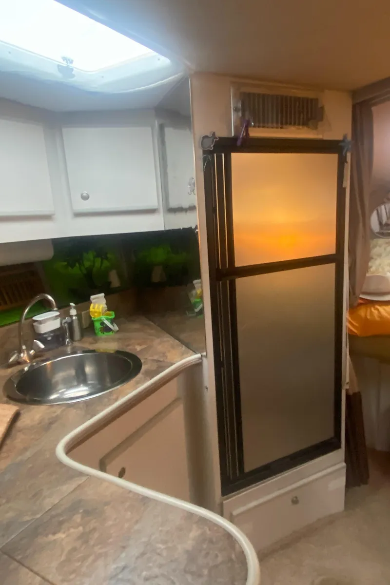 Slide: The Image of 1993 Cruisers 3675 yacht kitchen with sink and fridge. - 14