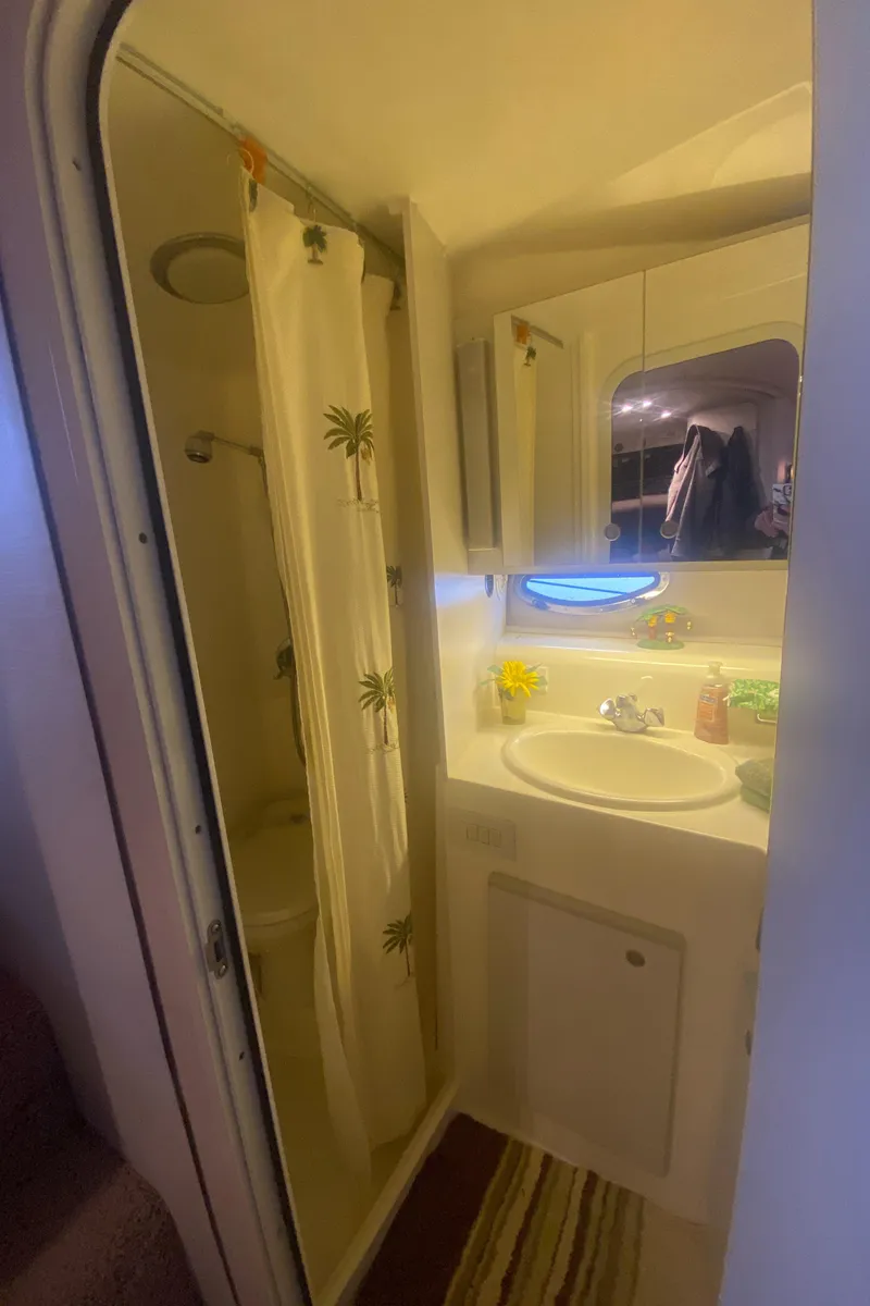 Slide: The Image of 1993 Cruisers 3675 boat bathroom with shower, sink, and mirror. - 15