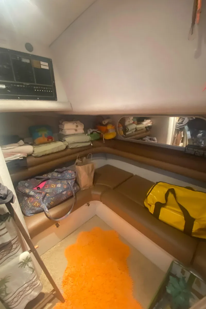 Slide: The Image of 1993 Cruisers 3675 cabin interior with seating, storage, and bags. - 19