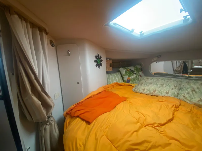 Slide: The Image of Cozy bedroom in a 1993 Cruisers 3675 yacht with skylight and vibrant bedding. - 21
