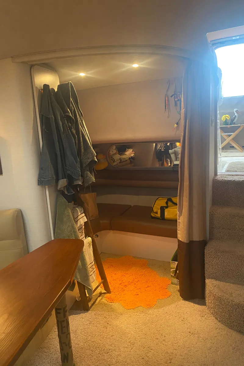 Slide: The Image of 1993 Cruisers 3675 interior cabin with seating area and storage. - 24