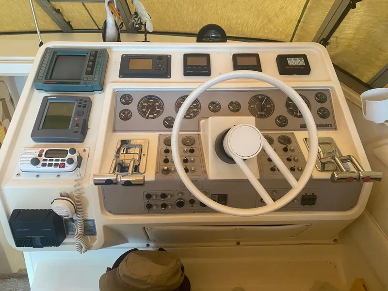Slide: The Image of 1993 Cruisers 3675 boat helm with navigation instruments and steering wheel. - 5