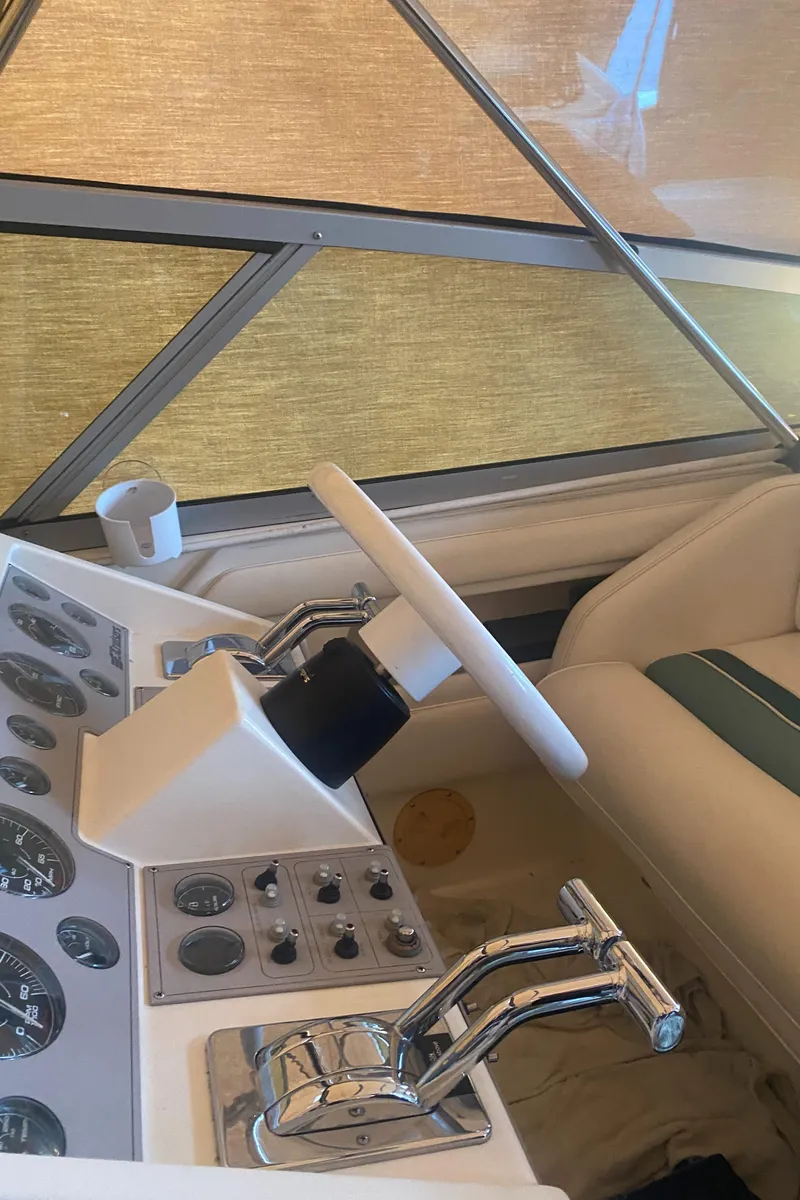 Slide: The Image of 1993 Cruisers 3675 boat helm with controls and steering wheel. - 6
