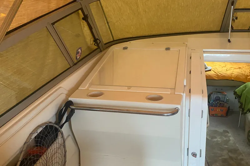 Slide: The Image of 1993 Cruisers 3675 boat interior with storage compartments and sleeping area. - 9