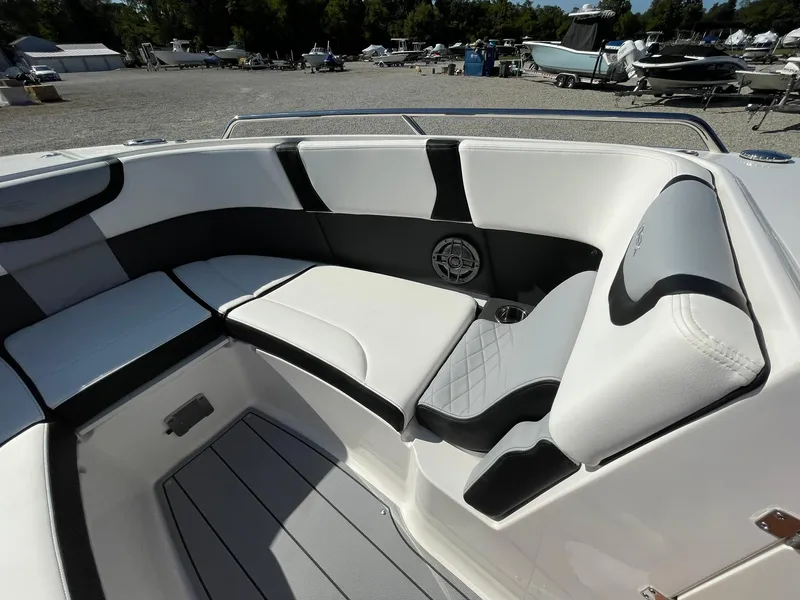 Slide: The Image of 2024 Chaparral 270 OSX boat interior with sleek seating and modern design. - 11