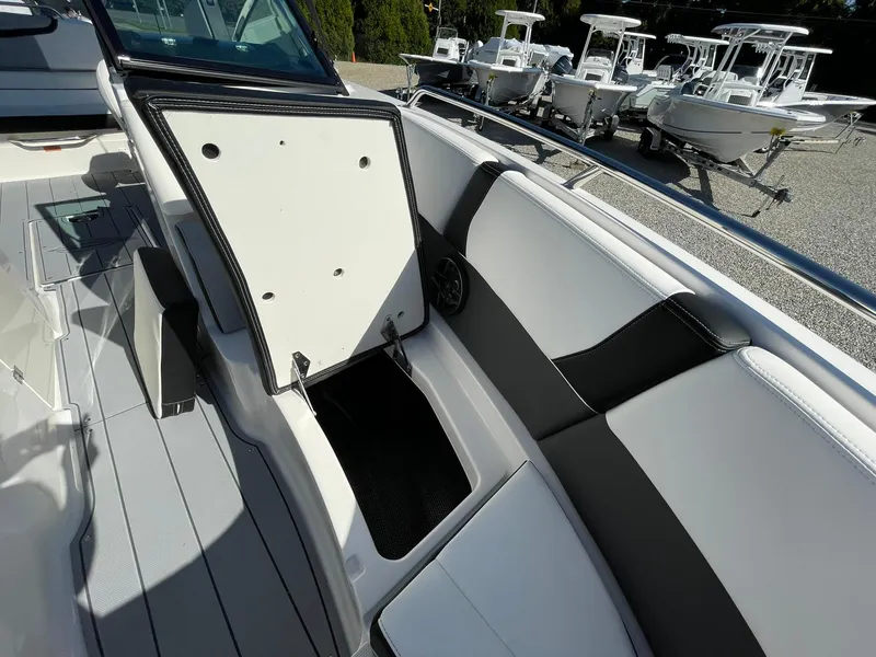 Slide: The Image of 2024 Chaparral 270 OSX boat interior with open storage compartment. - 17
