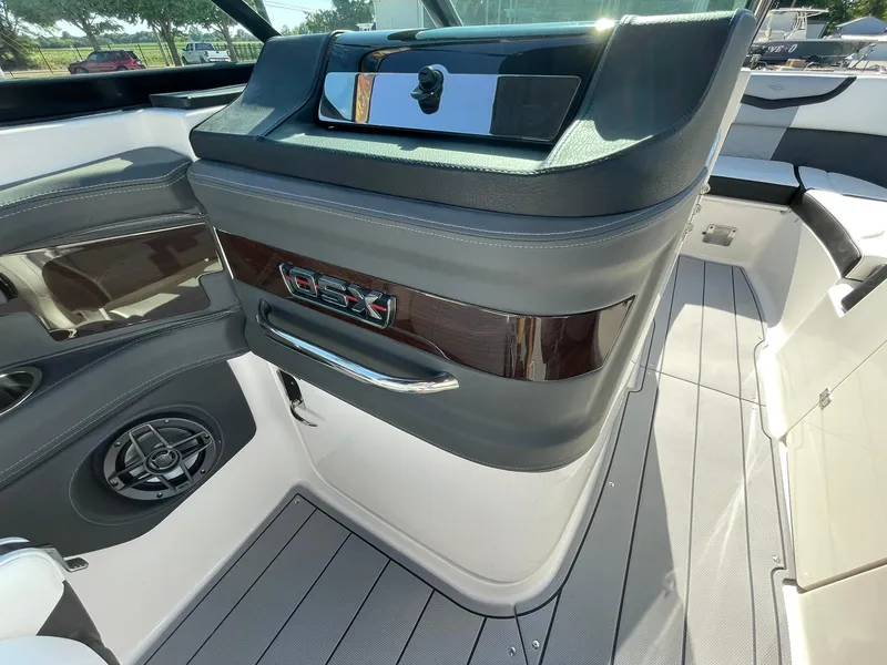 Slide: The Image of 2024 Chaparral 270 OSX boat interior with sleek dashboard and modern design. - 39