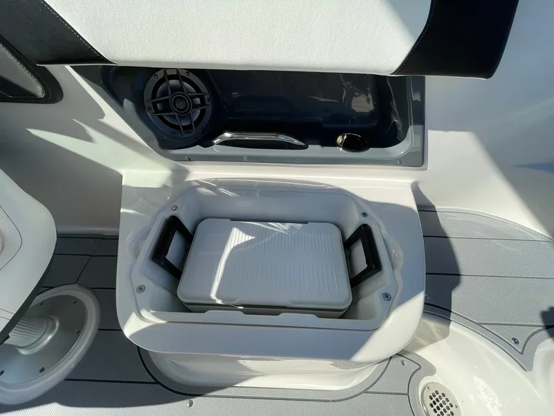 Slide: The Image of 2024 Chaparral 270 OSX boat interior with storage compartment and speaker. - 48