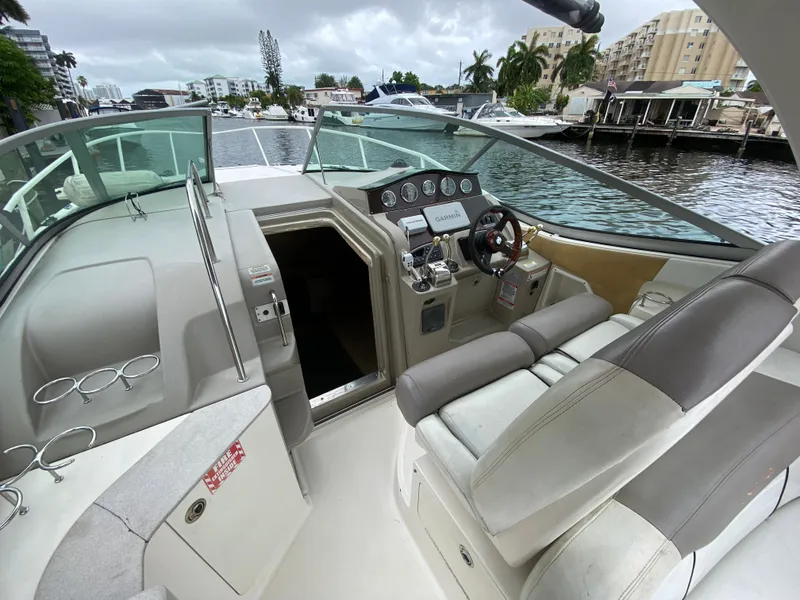 Slide: The Image of 2008 Sea Ray 310 Sundancer boat interior with helm and seating area. - 13
