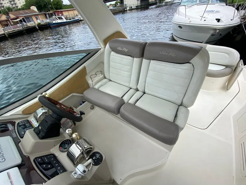 Slide: The Image of 2008 Sea Ray 310 Sundancer helm with dual seats and control panel. - 14
