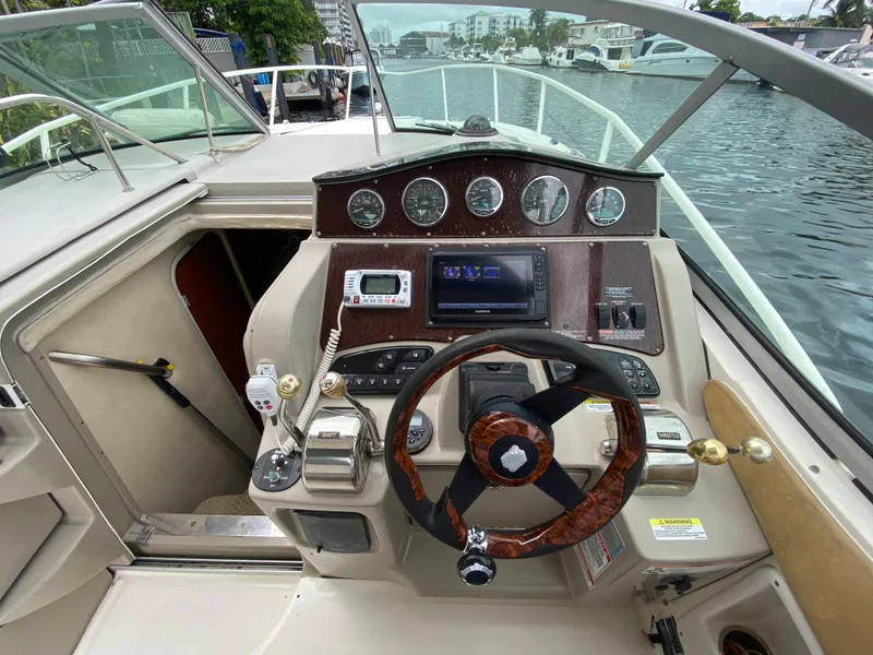 Slide: The Image of 2008 Sea Ray 310 Sundancer boat helm with steering wheel and control panel. - 15
