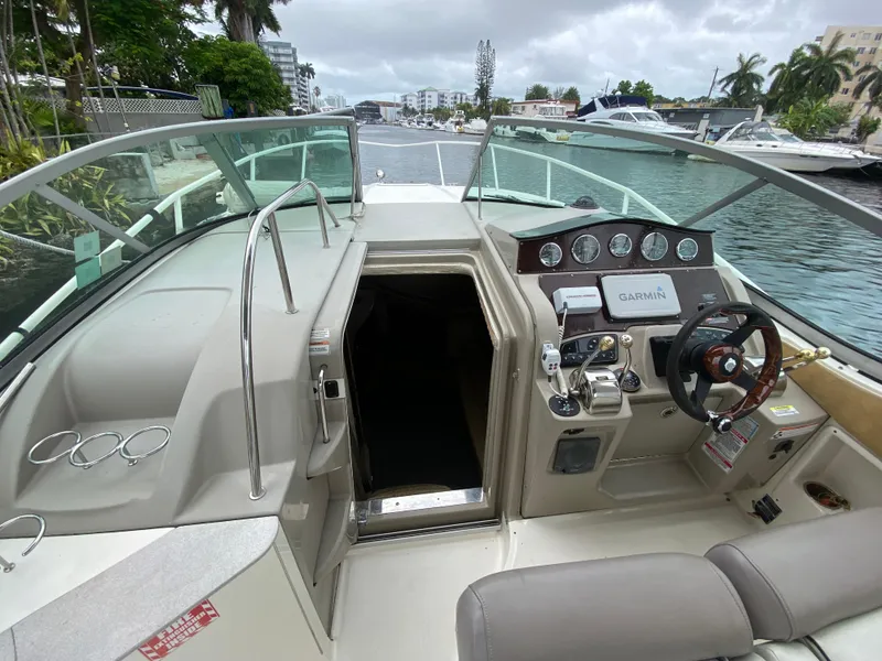 Slide: The Image of 2008 Sea Ray 310 Sundancer cockpit with helm, controls, and cabin entrance. - 16