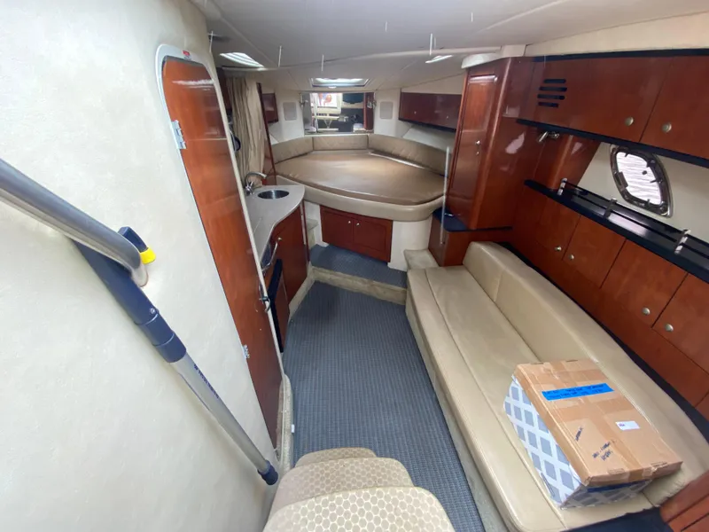 Slide: The Image of Interior of 2008 Sea Ray 310 Sundancer yacht with kitchenette, seating, and sleeping area. - 17