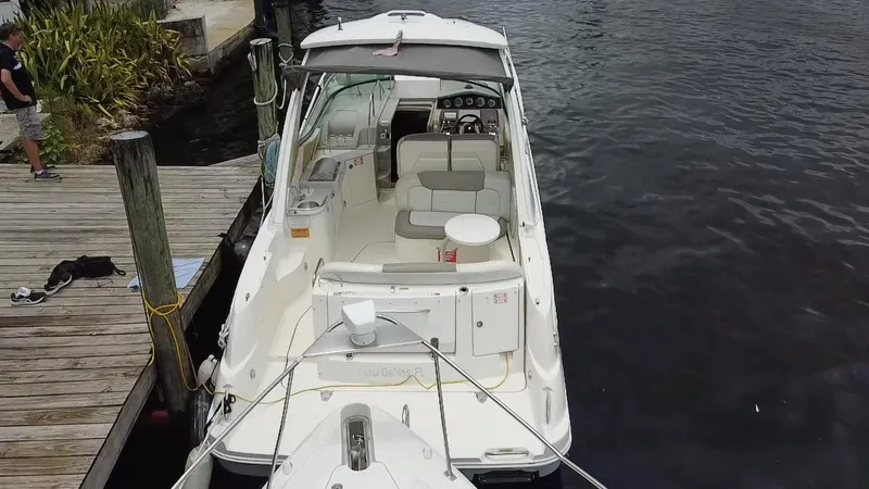 Slide: The Image of 2008 Sea Ray 310 Sundancer docked, top view of cockpit and seating area. - 23