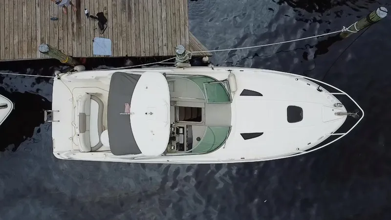 Slide: The Image of Top view of a 2008 Sea Ray 310 Sundancer docked at a wooden pier. - 24