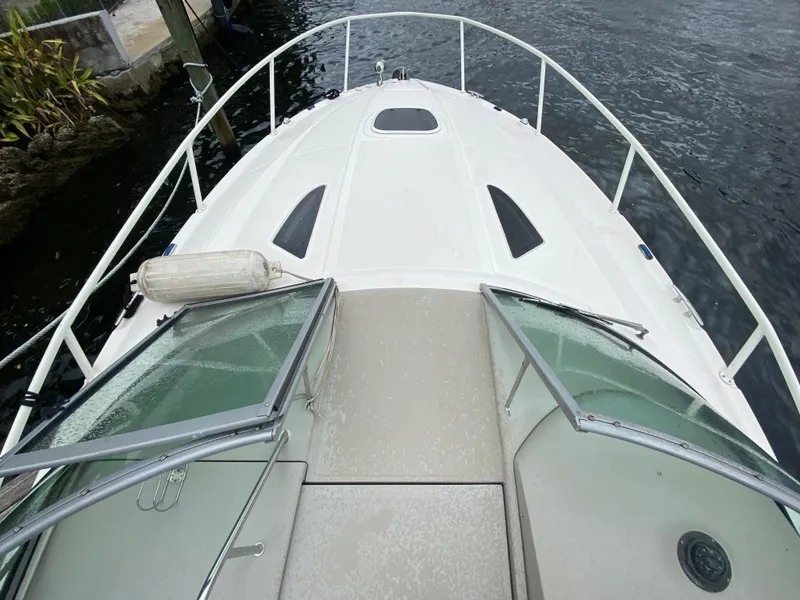 Slide: The Image of 2008 Sea Ray 310 Sundancer boat deck view with open windshield. - 6