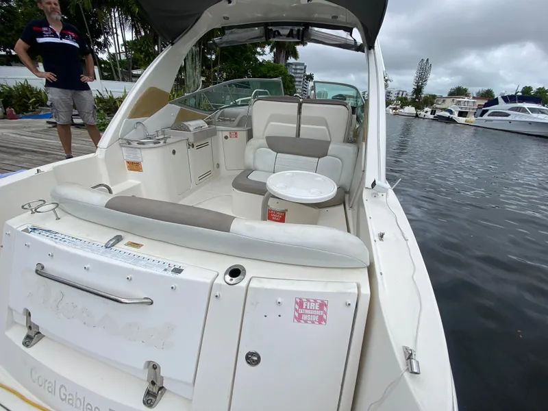 Slide: The Image of 2008 Sea Ray 310 Sundancer boat interior with seating and table, docked at marina. - 8
