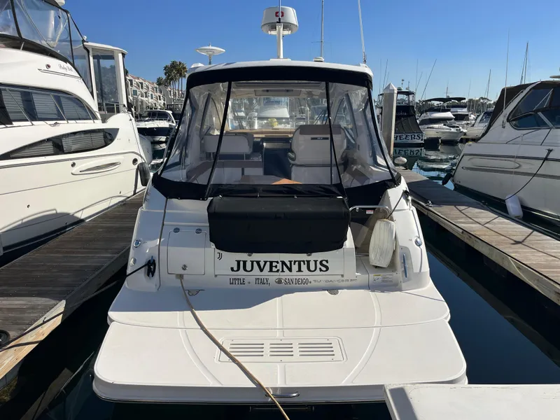 Slide: The Image of 2018 Sea Ray Sundancer 350 docked at marina, rear view with clear skies. - 2