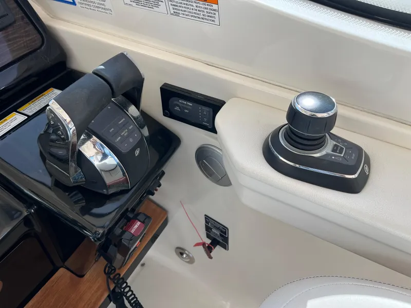 Slide: The Image of 2018 Sea Ray Sundancer 350 helm controls with joystick and throttle. - 24