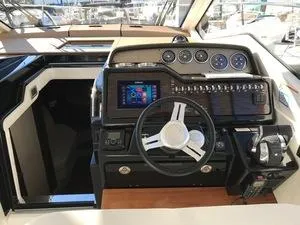 Slide: The Image of 2018 Sea Ray Sundancer 350 helm with modern controls and navigation system. - 6