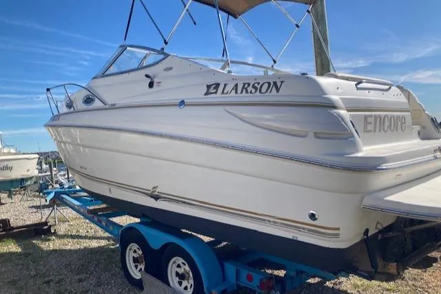 Slide: The Image of 2004 Larson 240 Cabrio boat on trailer, side view, sunny day. - 2