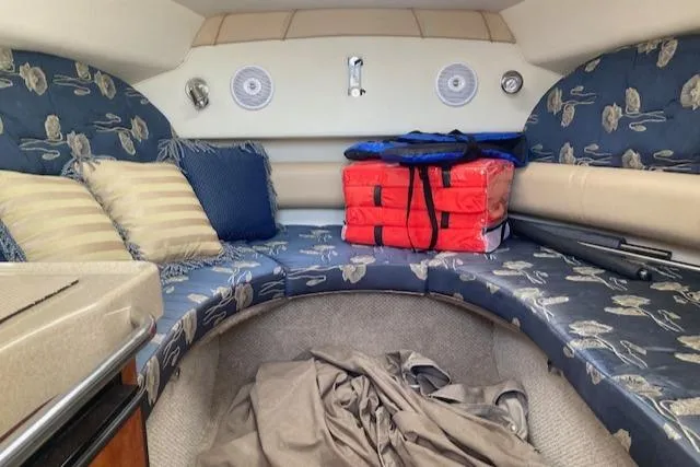 Slide: The Image of Interior cabin of a 2004 Larson 240 Cabrio boat with cushions and storage. - 6
