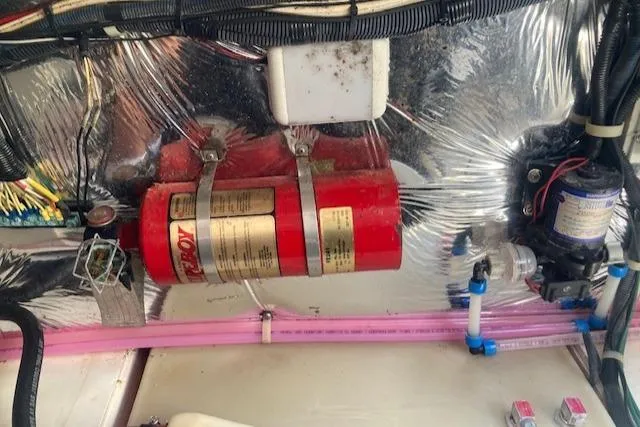 Slide: The Image of Engine compartment of a 2004 Larson 240 Cabrio with fire extinguisher and wiring. - 7