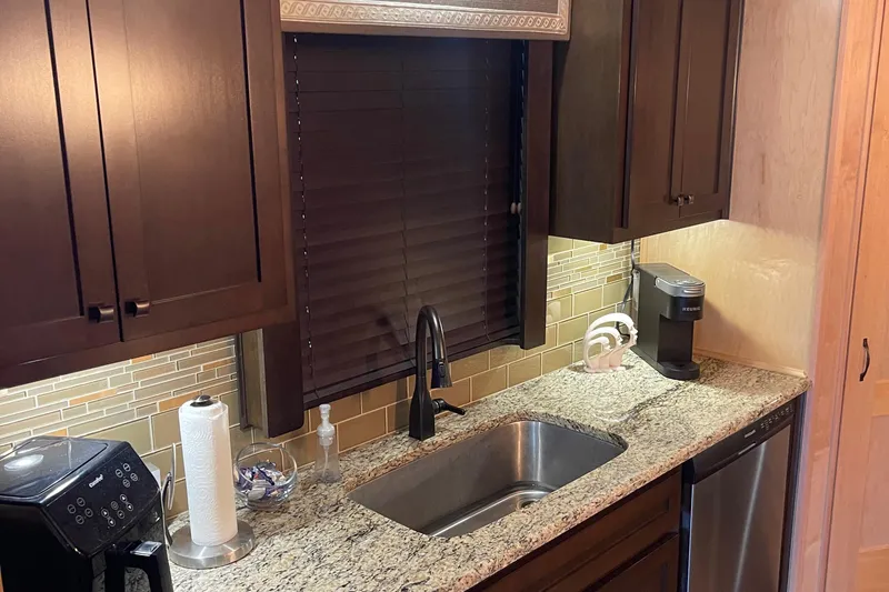 Slide: The Image of Modern kitchen in 2018 Sumerset Show Boat with granite countertops and dark wood cabinets. - 15