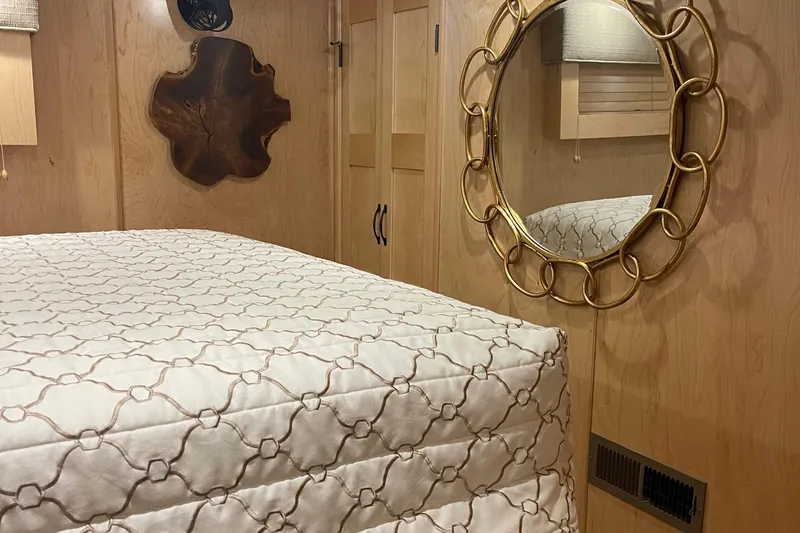 Slide: The Image of Sumerset Show Boat 2018 bedroom interior with bed, mirror, and wooden decor. - 26