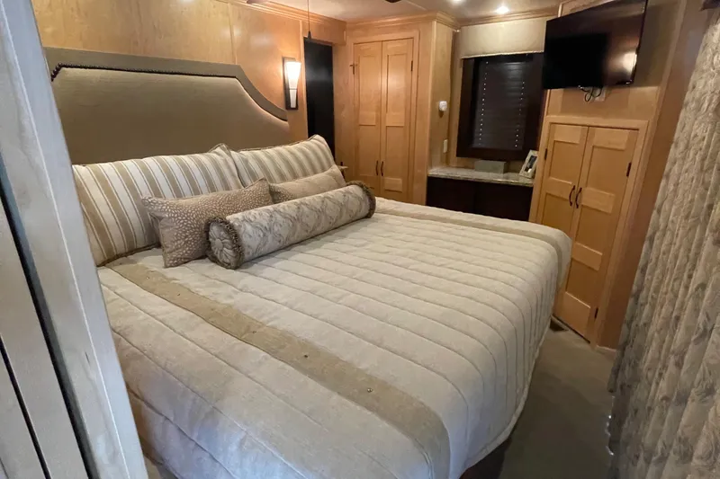Slide: The Image of Luxurious bedroom in a 2018 Sumerset Show Boat with a large bed and modern amenities. - 39