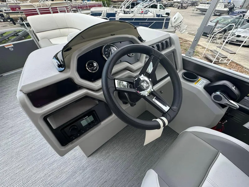 Slide: The Image of 2024 Sweetwater 2086 CX boat dashboard with steering wheel and control panel. - 3