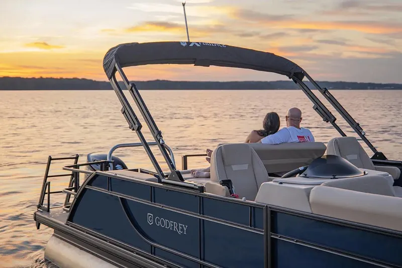 Slide: The Image of Couple enjoying sunset on 2024 Sweetwater 2086 CX pontoon boat. - 4