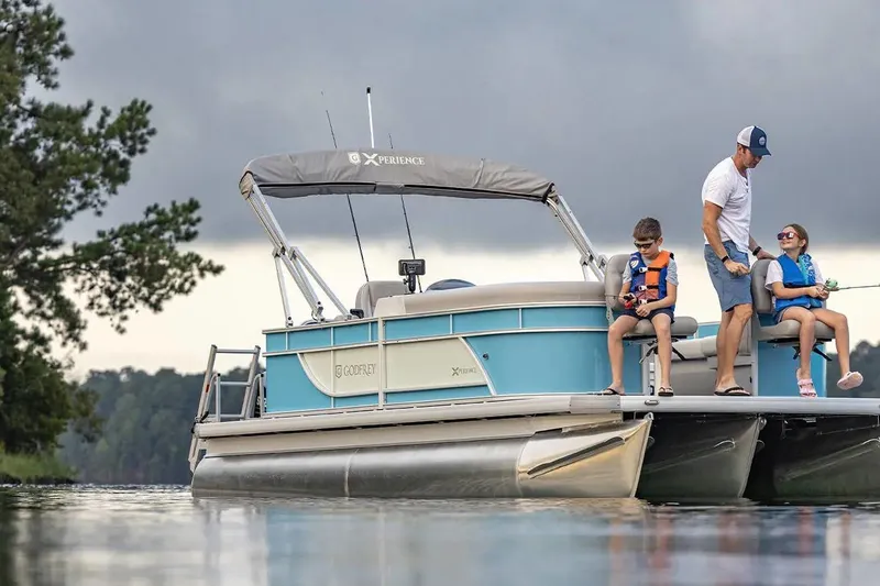 Slide: The Image of 2024 Sweetwater 2086 CX pontoon boat with family fishing on a lake. - 5