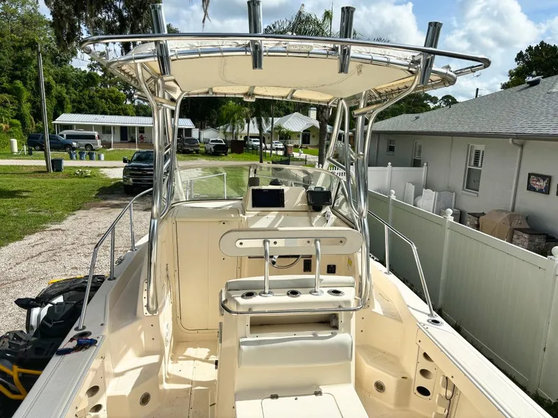 Slide: The Image of 2005 Key West 2300 Walkaround boat with center console and T-top in a residential area. - 1