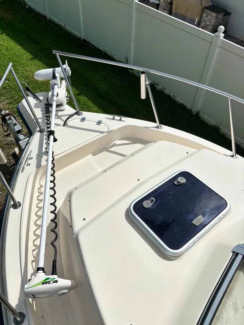 Slide: The Image of 2005 Key West 2300 Walkaround boat deck with trolling motor and hatch. - 3