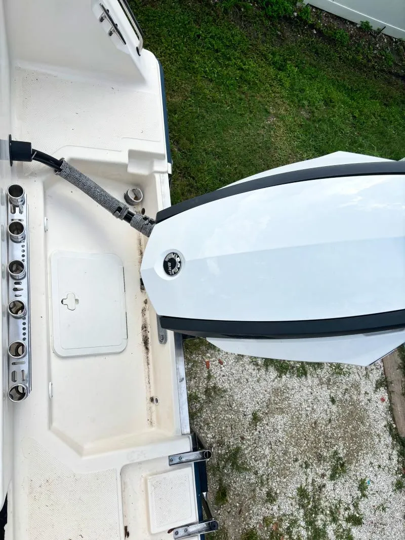 Slide: The Image of 2005 Key West 2300 Walkaround boat stern with outboard motor and fishing rod holders. - 4