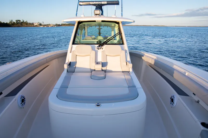 Slide: The Image of 2026 Scout 425 LXF boat interior with luxurious seating on calm water. - 13