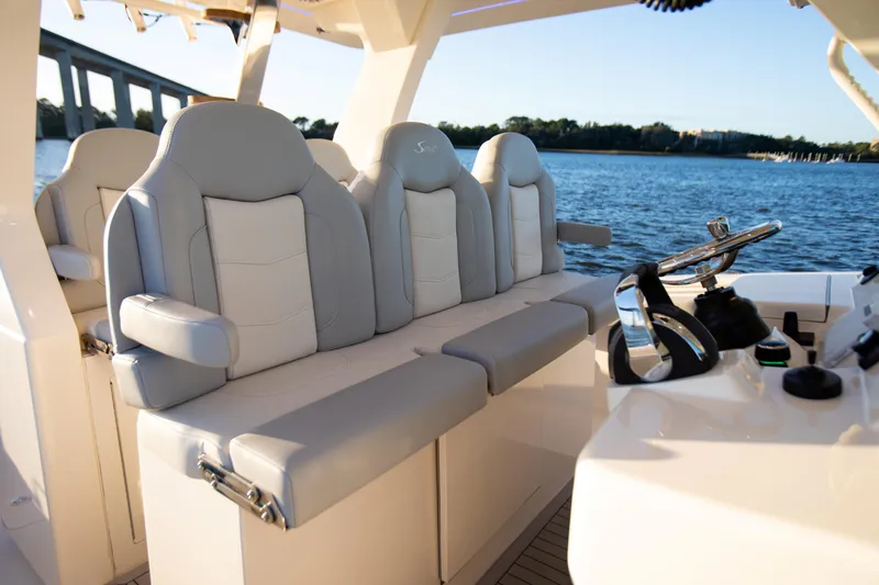 Slide: The Image of Luxury seating on 2026 Scout 425 LXF boat, with helm and water view. - 15