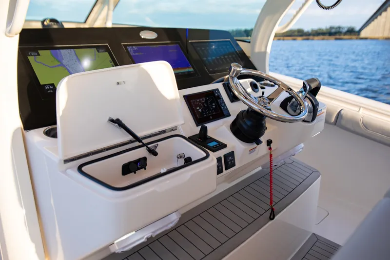 Slide: The Image of Helm of 2026 Scout 425 LXF boat with advanced navigation displays and controls. - 17