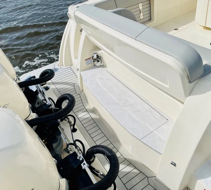 Slide: The Image of 2026 Scout 425 LXF boat with dual engines and sleek seating on the water. - 22