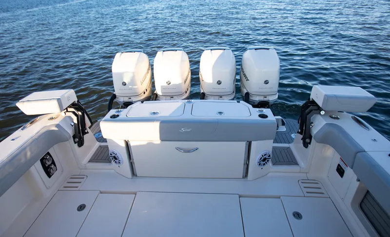 Slide: The Image of 2026 Scout 425 LXF boat with four powerful outboard engines on open water. - 24