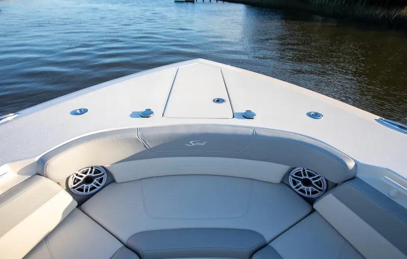 Slide: The Image of 2026 Scout 425 LXF boat interior with cushioned seating and water view. - 7