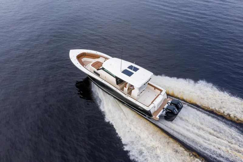 Slide: The Image of 2026 Scout 425 LXF boat cruising on open water, aerial view. - 8