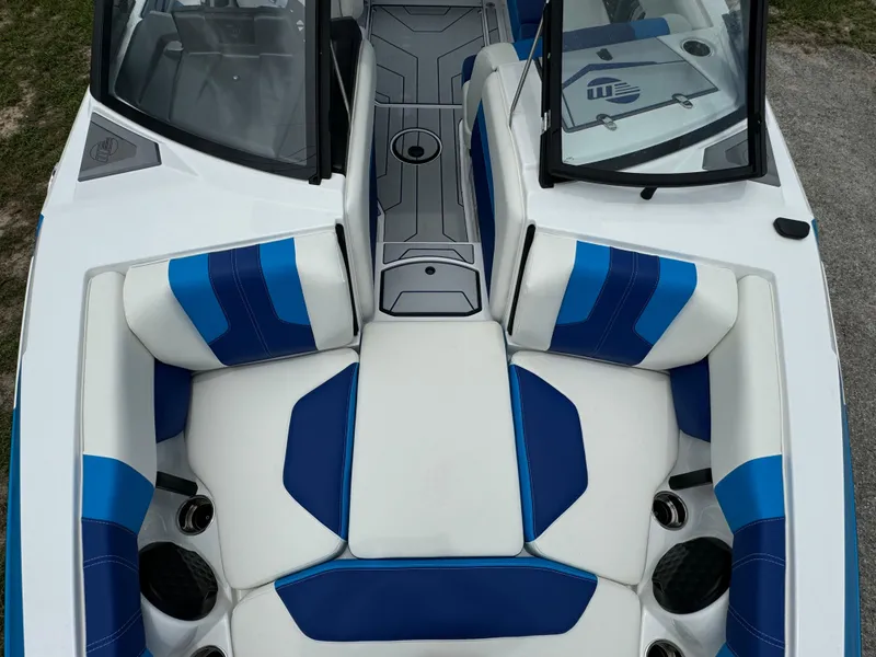 Slide: The Image of 2024 Malibu Wakesetter 21 LX boat interior with blue and white seating. - 14
