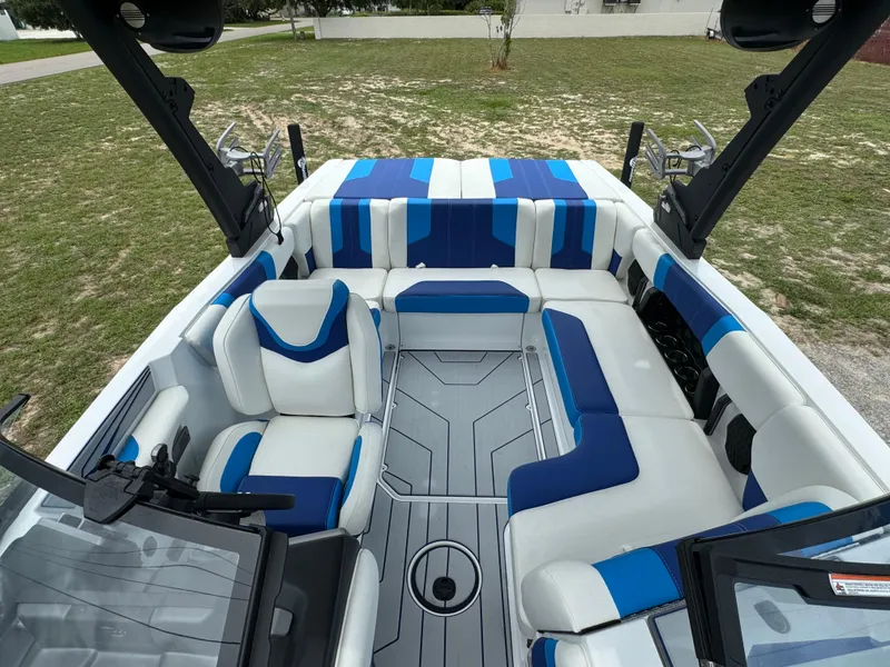 Slide: The Image of 2024 Malibu Wakesetter 21 LX interior with blue and white seating. - 18