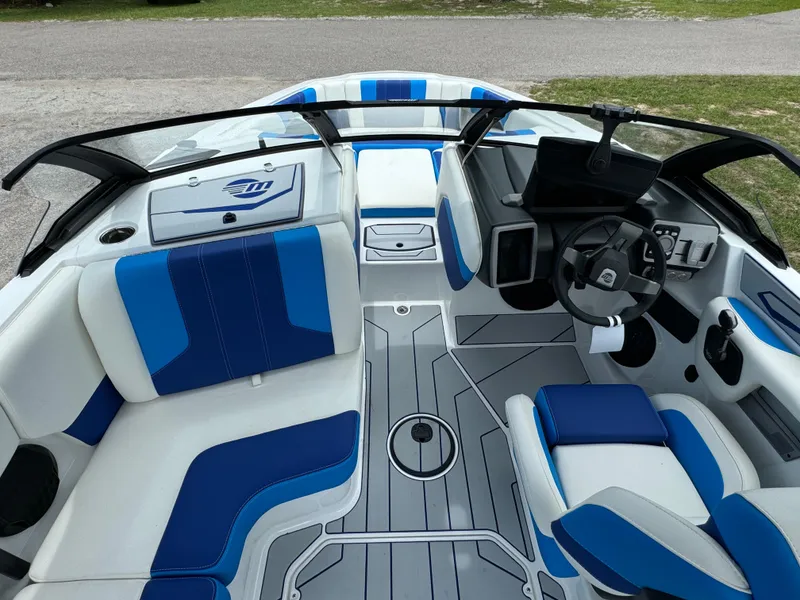 Slide: The Image of 2024 Malibu Wakesetter 21 LX interior with blue and white seating. - 19