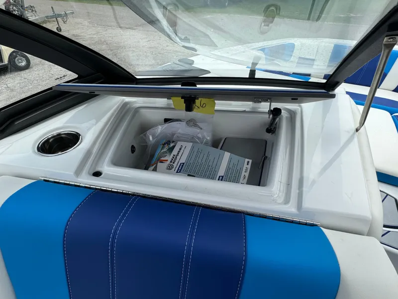 Slide: The Image of 2024 Malibu Wakesetter 21 LX storage compartment with blue and white interior. - 20