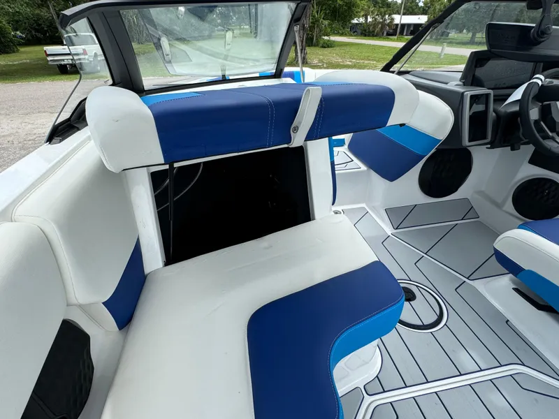 Slide: The Image of 2024 Malibu Wakesetter 21 LX interior with blue and white seating. - 21